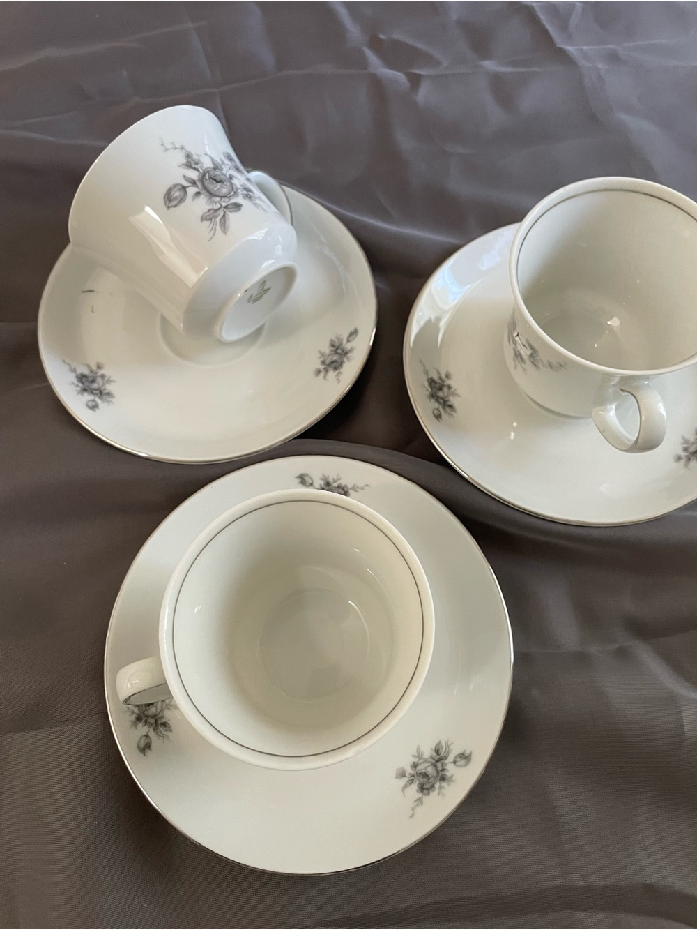 Elegant White Porcelain Tea Cup and Saucer Set with Gray Floral Trim